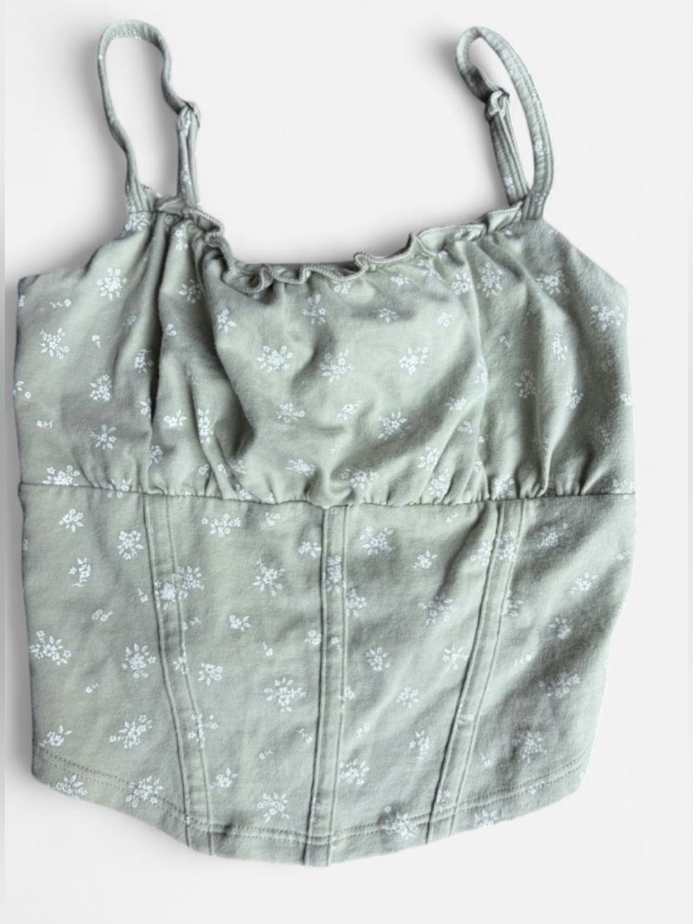 Hollister Sz. XS light green corset-
like crop top with white floral print.
